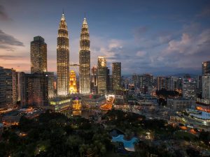 An aerial image of the Petronas Twin Towers and Kuala Lumpur city 