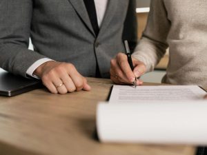 A person signing a travel insurance contract 