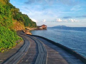 The boardwalk at Rawa Island Resort in the evening 