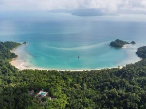 Aerial view of the green forest and blue water of Datai Bay, Langkawi 